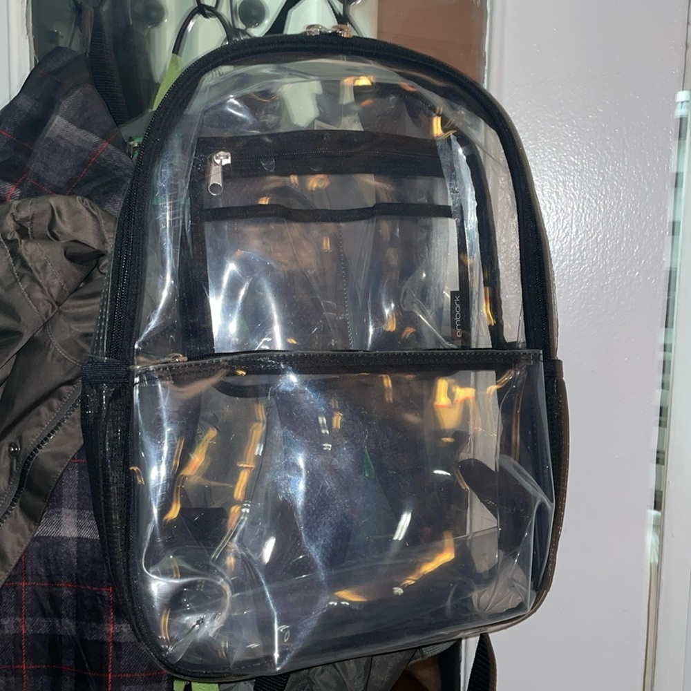 NWT Clear Plastic Backpack by EMBARK Black outline on nearly transparent bag.